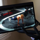 A photo of the Peloton's swivel screen with a fitness class